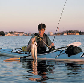 Catching fish on a kayak.